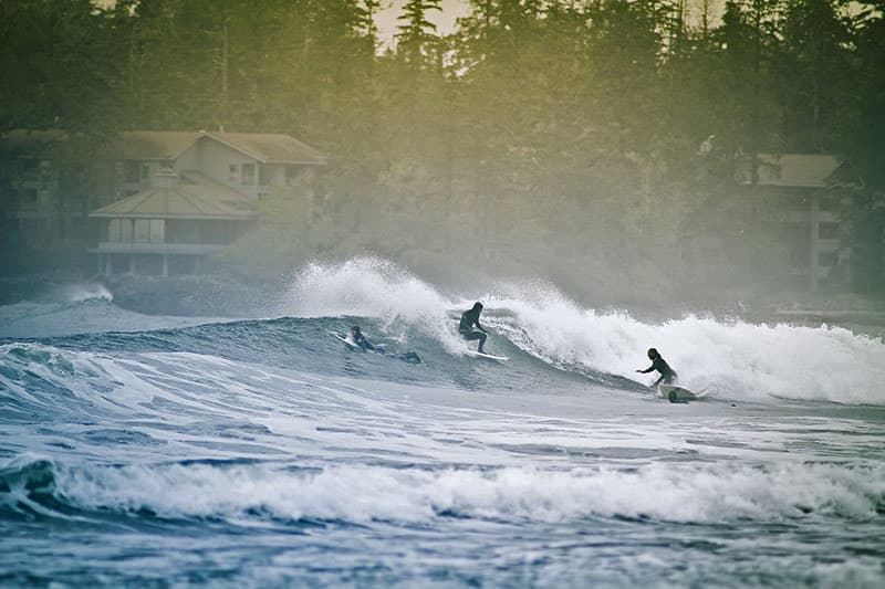 Surfer at Chesterman Beach, Tofino at golden sunset