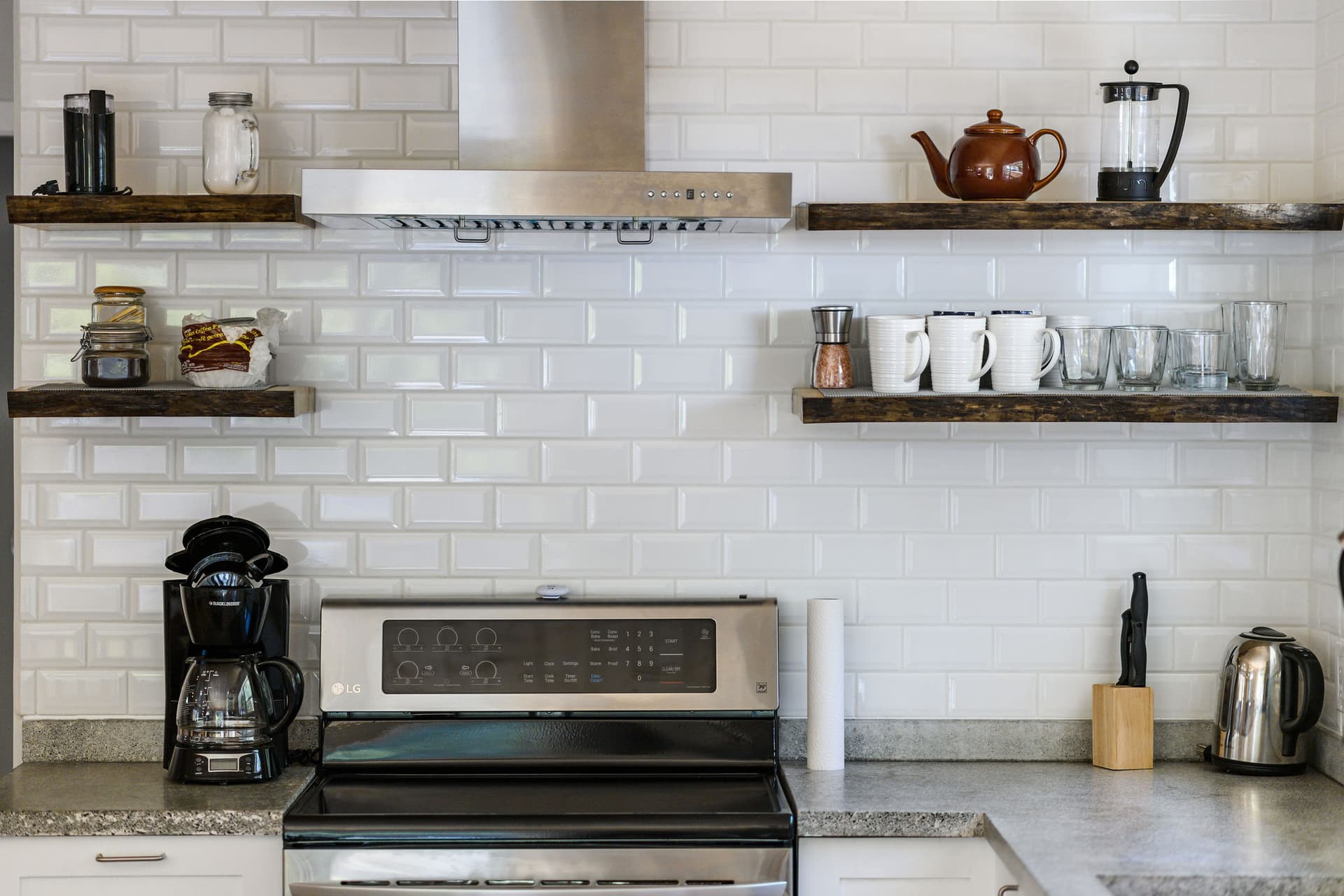Kitchen range with open shelving and subway tile