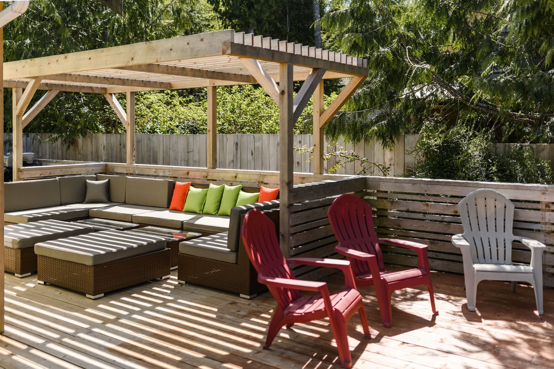 Large deck with outdoor lounge furniture and barrel sauna