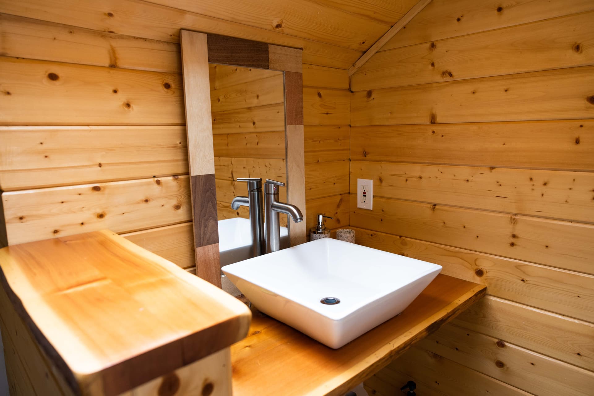 Bathroom with wooden vanity and vessel sink