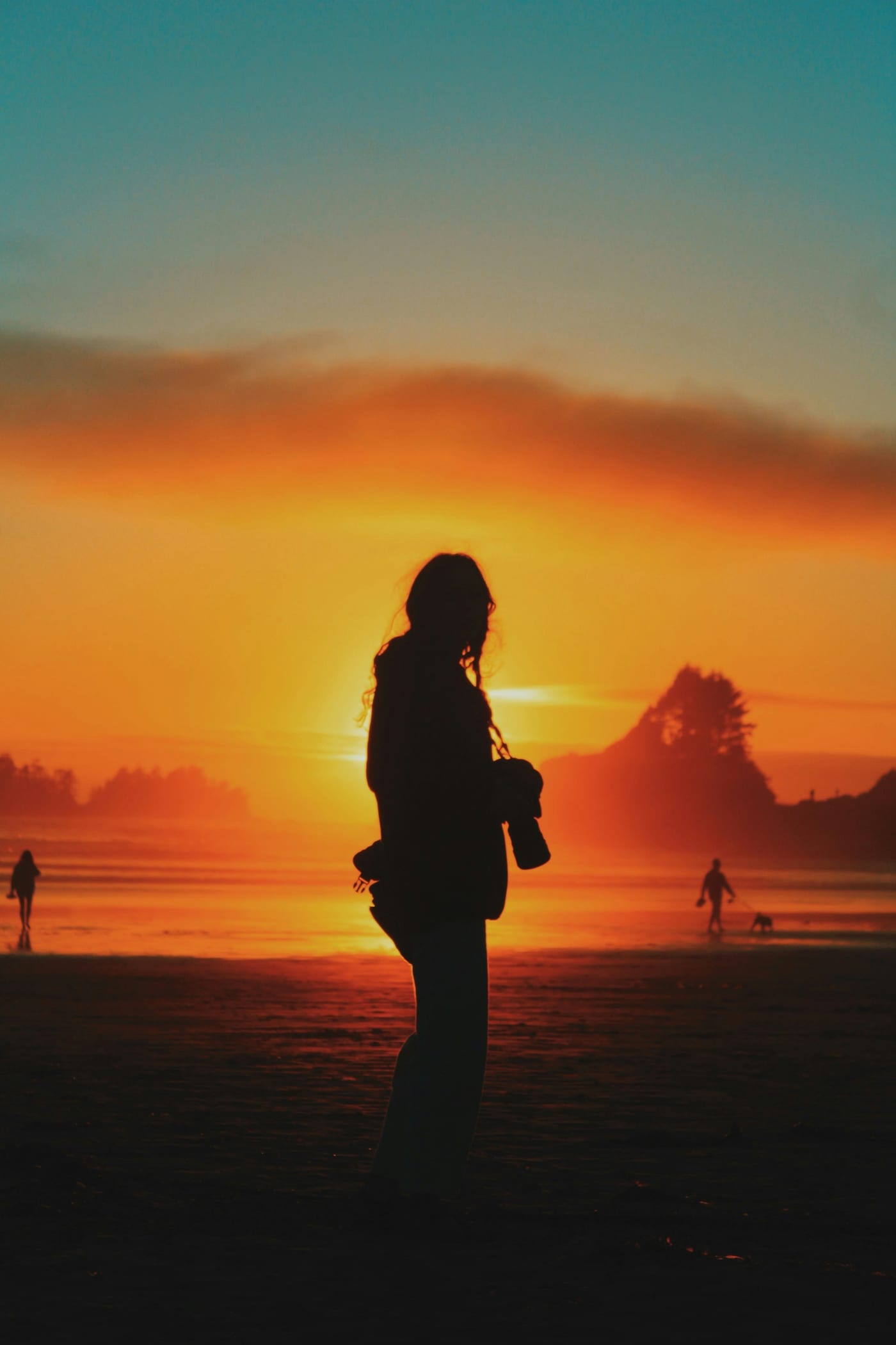 Surfer on a Tofino beach in wetsuit ready to paddle out